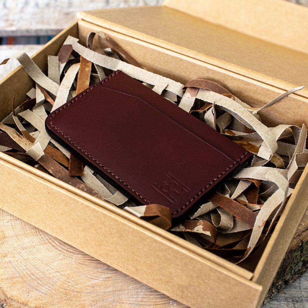 Packaging shot showing brown modern handmade leather cardholder.