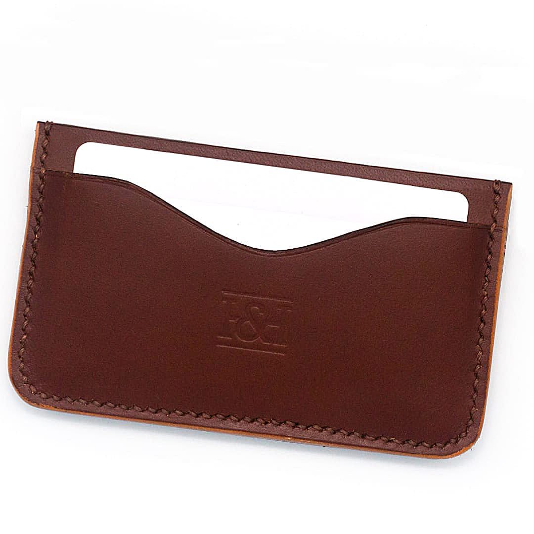 2 slot leather cardholder with wavey slots and cards.